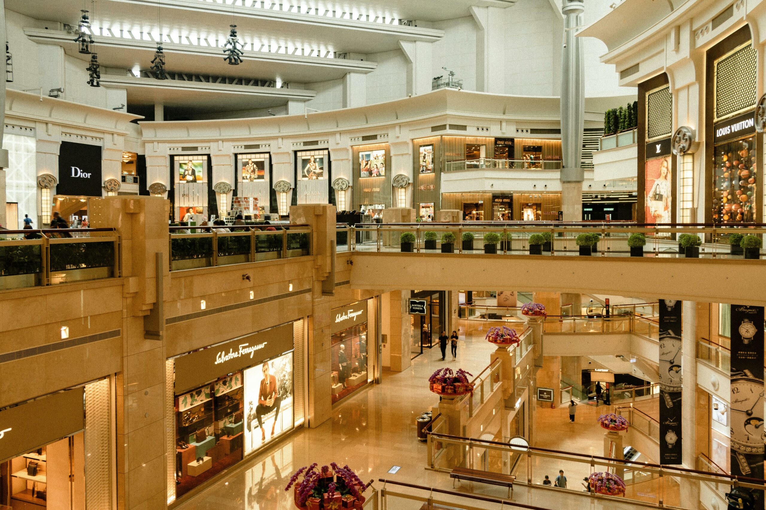 pexels-photo-4027948-4027948 Contemporary design of big mall interior with ribbed column and decorative elements on ceiling with glowing corridors illuminated by artificial lights and signboards with inscriptions