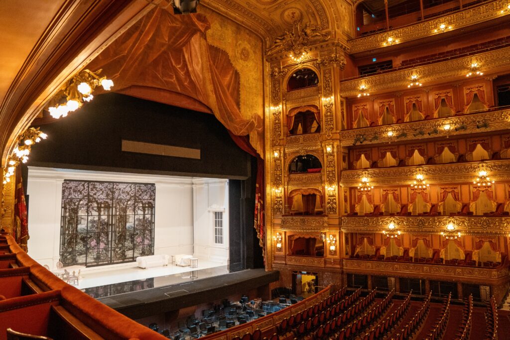 A stunning interior view of Teatro Colón in Buenos Aires showcasing the opulent decor and stage area.
