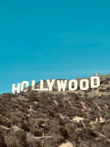 Famous Hollywood Sign under clear blue skies in Los Angeles, CA.